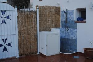 a bathroom with a white door and a fence at Donna Rosalia in Amalfi
