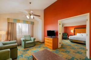 a hotel room with a bed and a television at La Quinta Inn by Wyndham Cheyenne in Cheyenne +34 photos
