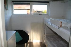 a small bedroom with a bunk bed and a window at Rekerlanden 195 in Schoorldam