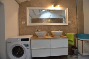 a bathroom with two sinks and a washing machine at Noanna Apartment in Rovinj