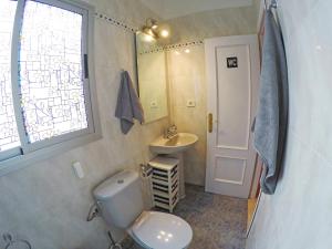 a small bathroom with a toilet and a sink at Mi Tía holiday home with terrace in San Andrés +17 photos