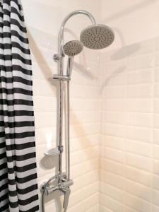 a shower with two lights in a bathroom at Diamond Apartments in Bucharest
