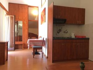 une cuisine avec des placards en bois et une table dans l'établissement Villa Siga, à Mali Ston
