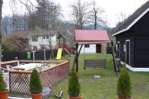 a playground in a yard with a swing at Pensiunea Vladut in Bran