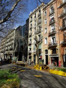 an empty street in a city with tall buildings at Apartamenting Barcelona in Barcelona