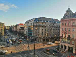 a busy city street with cars and buildings at Bauhaus Astoria Hostel in Budapest