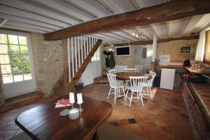 a kitchen and dining room with a table and chairs at L'Etable du Domaine des Buissonnets in Écardenville-sur-Eure +8 photos