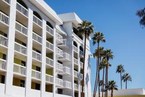 an exterior view of a building with palm trees at Holiday Inn & Suites Phoenix-Mesa-Chandler, an IHG Hotel in Mesa