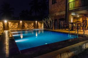 a large swimming pool at night at Negombo Boutique Villa in Negombo