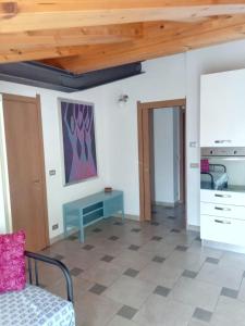 a living room with a wooden ceiling and a table at Cà Nosent in Pisogne