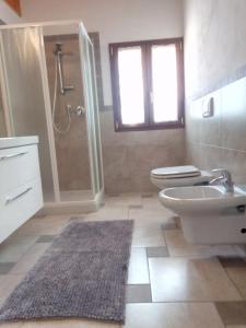 a bathroom with a toilet and a sink and a shower at Cà Nosent in Pisogne