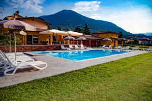 a villa with a swimming pool and lounge chairs at B&B Ca' Marognole in Caprino Veronese