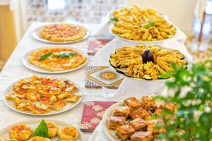 a table with many plates of food on it at Hotel San Giorgio Terme in Ischia