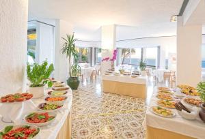a buffet line with plates of food in a restaurant at Hotel San Giorgio Terme in Ischia
