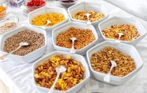 a table topped with trays of different food with spoons at Hotel San Giorgio Terme in Ischia
