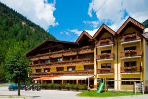 a hotel in the mountains with motorcycles parked in front of it at Hotel Neue Post in Sölden
