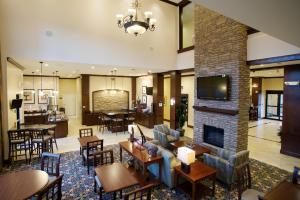a lobby with a fireplace and tables and chairs at Staybridge Suites San Antonio Sea World, an IHG Hotel in San Antonio