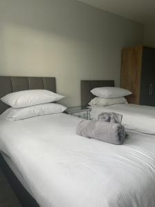 2 camas juntas con almohadas en Hydrangea House en Kinsale