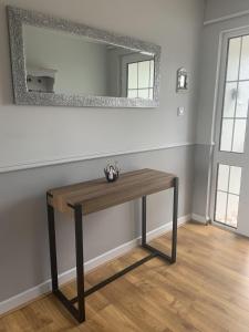 a wooden table in a room with a mirror at Hydrangea House in Kinsale