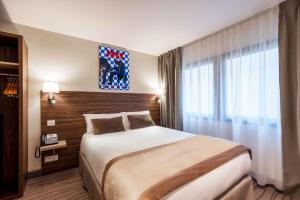 Postel nebo postele na pokoji v ubytování Quality Hotel Toulouse Centre