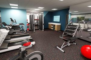 a gym with treadmills and machines in a room at Avid Hotels - Oklahoma City - Quail Springs, an IHG Hotel in Oklahoma City