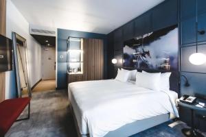 a bedroom with a bed and a desk at Radisson Blu Hotel, Madrid Prado in Madrid