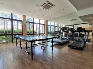 a gym with a ping pong table and tread machines at Lanta for Rest Boutique in Ko Lanta