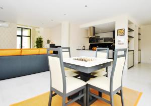 a kitchen and living room with a table and chairs at Villa Bahamas by Algarve Vacation in Armação de Pêra +42 photos