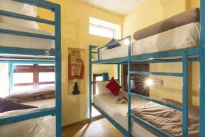 a room with three bunk beds and a window at Hotel Golden City with Swimming Pool in Jaisalmer