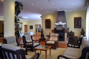 a living room filled with furniture and a fireplace at Hotel O Colmo in Santana