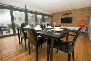 a dining room with a black table and chairs at The Edge - Parking - by Brighton Holiday Lets in Brighton & Hove