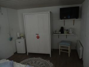 a bedroom with a door and a chair and a bed at Chez Carole et Roger in Avignon
