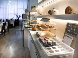 a kitchen with a counter with food on it at Hotel Zen in Lignano Sabbiadoro