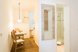 a bathroom with a shower and a table with a chair at Haus Zobler in Binz +95 photos