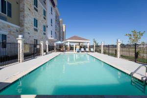 a swimming pool in front of a building at Candlewood Suites - Buda - Austin SW, an IHG Hotel in Buda