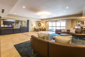 a lobby of a hotel with couches and a bar at Candlewood Suites - Buda - Austin SW, an IHG Hotel in Buda