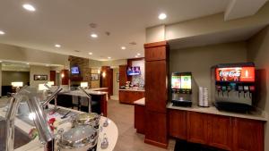 a restaurant with a bar with a soda machine at Staybridge Suites Ann Arbor - Research Parkway, an IHG Hotel in Ann Arbor