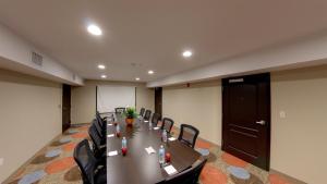 a conference room with a long table and chairs at Staybridge Suites Ann Arbor - Research Parkway by IHG in Ann Arbor +29 photos