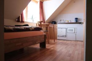 a room with a bed and a kitchen at Ferienwohnungen Grüne Tanne in Thale