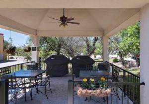 a patio with tables and chairs and a ceiling fan at Candlewood Suites Austin North-Cedar Park, an IHG Hotel in Cedar Park