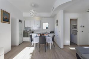 a kitchen and dining room with a table and chairs at Casa Colombo by Wonderful Italy in Genoa