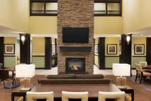 a living room with a couch and a fireplace at Staybridge Suites West Edmonton, an IHG Hotel in Edmonton