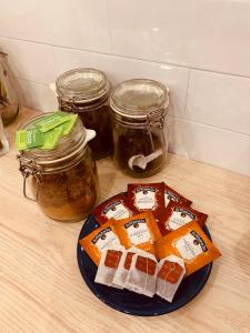 a plate of food on a counter with jars of honey at Sunny Stay Guest Houses in Alicante