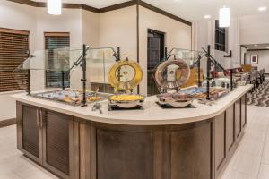 a buffet with bowls of food on a counter at Staybridge Suites Anchorage by IHG in Anchorage +65 photos