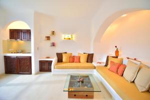 a living room with a couch and a table at Tamarix Del Mar Suites in Kamari