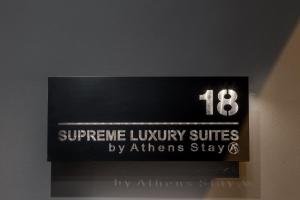 Un cartello su un muro con il numero sopra. di Supreme Luxury Suites by Athens Stay ad Atene