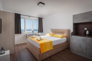a bedroom with a bed with two candles on it at Apartments Galic in Podgora