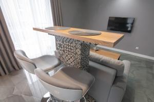 a bar with two chairs and a table in a room at Apartament Panorama in Nowy Targ