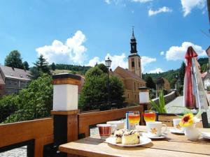 a table with food and drinks on a balcony at Apartamenty i pokoje gościnne "Wacuś" in Srebrna Góra