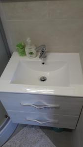 a white sink with a white towel on top of it at Apartment Iva in Rovinj